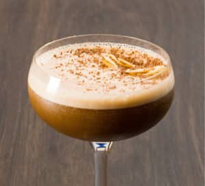 Photo of Latenight Game with vodka, blueberry coffee, Giffard Noix de Coco, and coffee liqueuer. Served up in a couple glass.