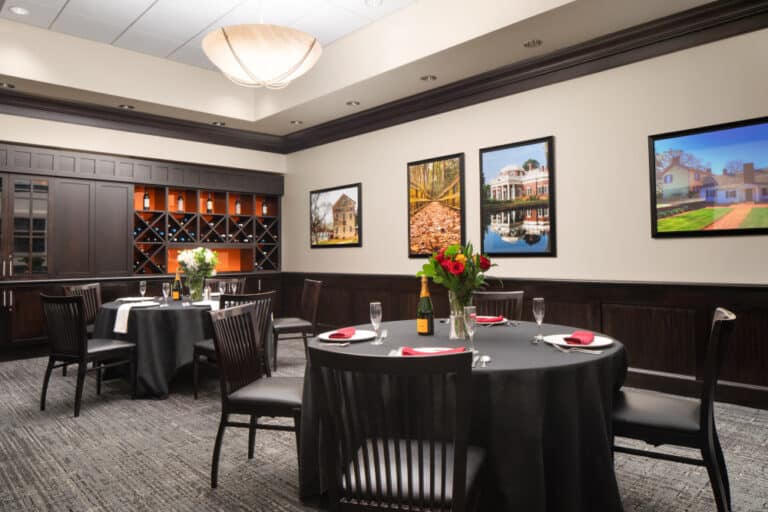 two tables set with flowers and champagne in a private dining area of the restaurant